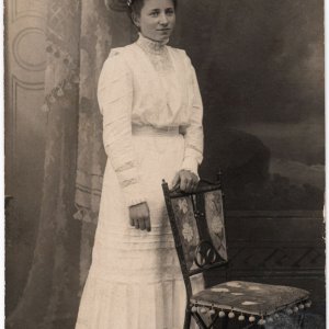 Dame in weißem Kleid und Hut